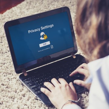 girl laptop typing privacy settings internet security